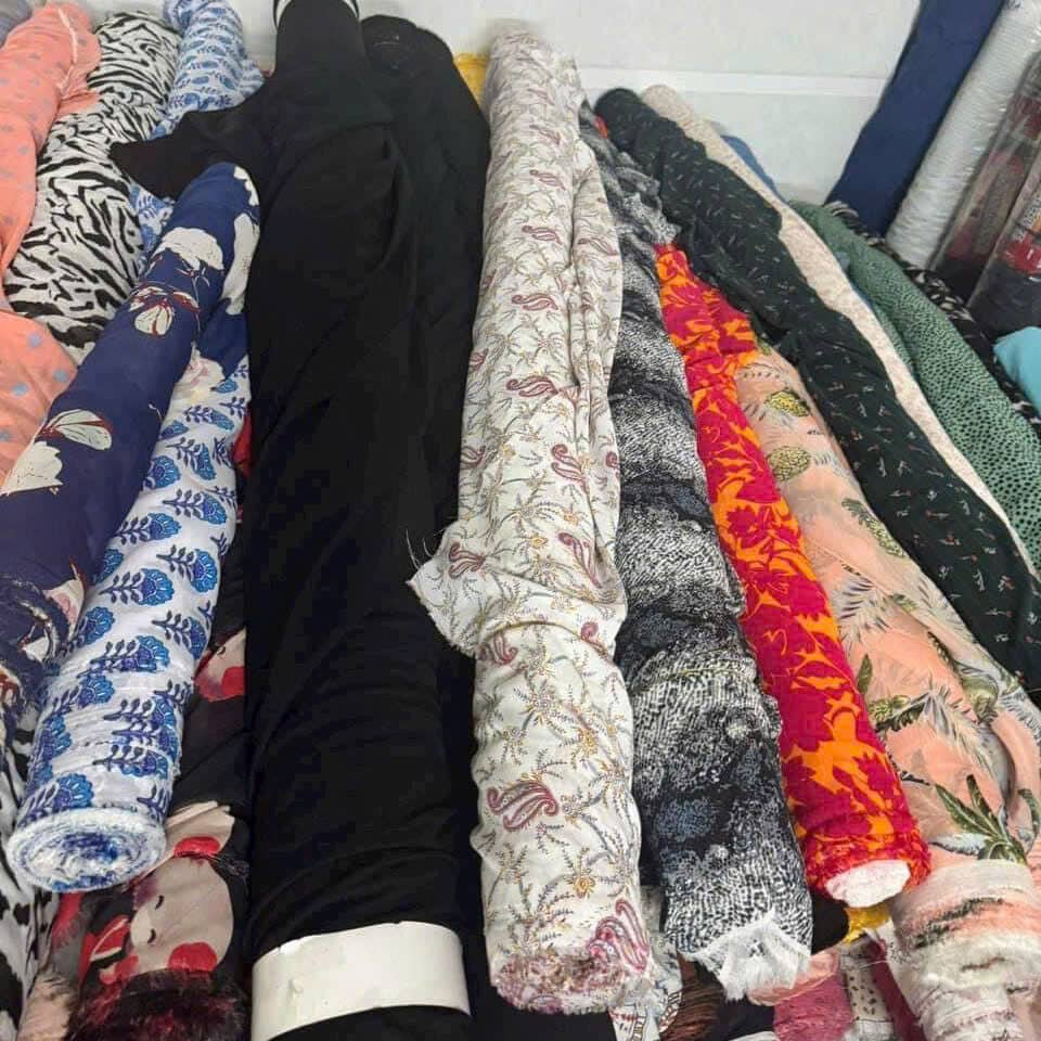 Printed floral fabrics in many designs, some rolls with misregistered prints